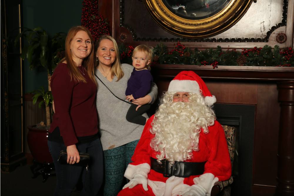 Santa posing with family of three